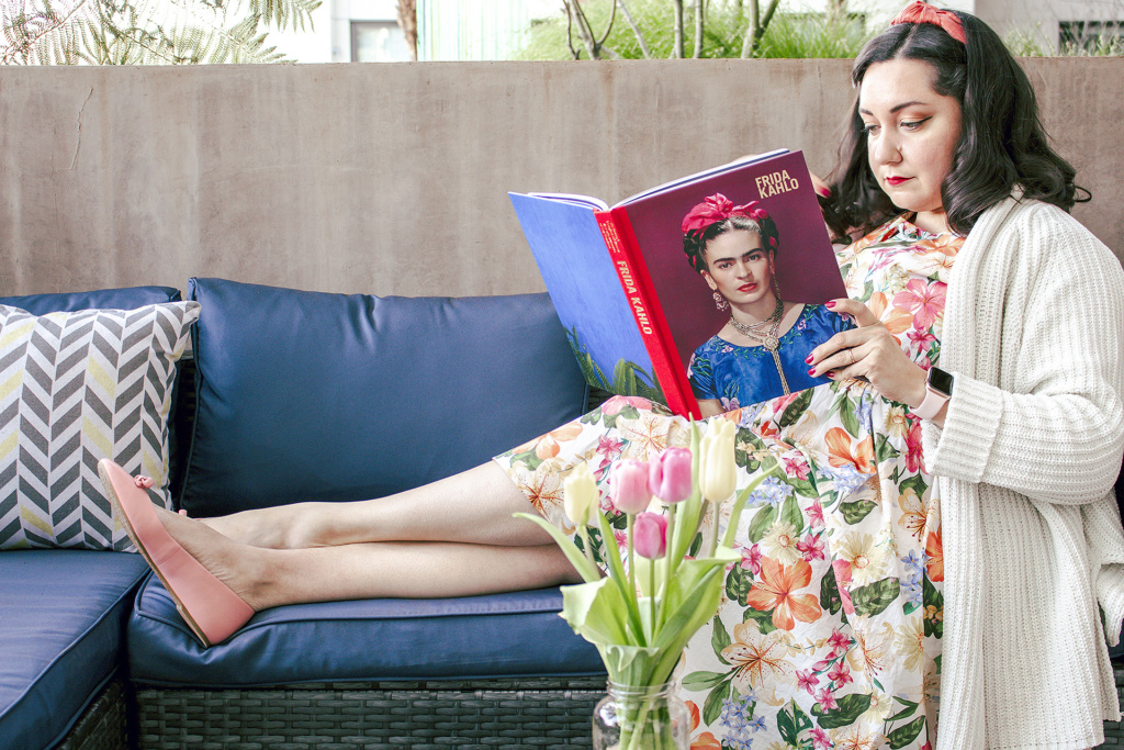 Bianca reading a book about Frida Kahlo outside